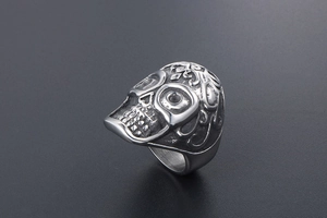 Top view of vintage titanium steel skull ring with intricate floral engraving details
