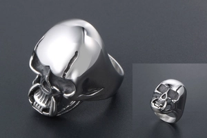 Macro detail of gothic skull ring with zombie fangs and polished silver steel finish