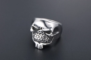 Close-up of gothic silver skull ring with detailed vintage finish and dark eye sockets