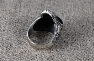 Macro side view of Gothic titanium steel ring with intricate grainy texture and antique finish