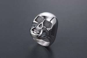 Detailed view of the 3D skull mask ring with silver finish and punk gothic details