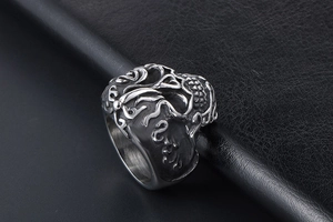 Macro detail of vintage skull ring with intricate cloud patterns in matte titanium steel