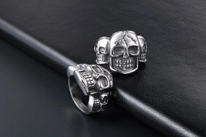 Detailed macro view of retro punk triple skull design ring in silver stainless steel