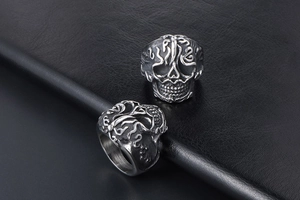 Detailed relief of vintage skull ring with intricate cloud pattern and aged steel finish