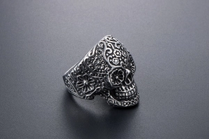 Detailed view of skull ring with Mexican Day of the Dead floral engraving patterns