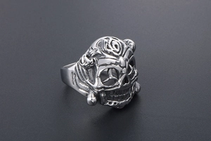 Macro detail of gothic skull ring in stainless steel with intricate punk engravings
