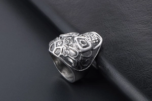 Macro shot of retro stainless steel skull ring with vintage floral pattern engraving