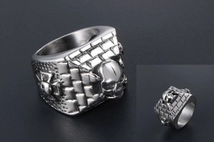 Macro shot of gothic skull ring with brick pattern texture and cross relief details