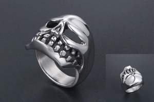 Macro shot of polished stainless steel skull ring showing detailed punk aesthetic design
