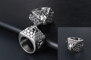Detail view of gothic steel skull ring with wall pattern and side cross engraving