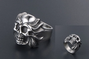 Detailed macro view of vintage silver skull ring with gothic punk flame texture side carvings