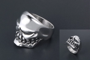 Macro detail of punk style skull ring showing silver finish and intricate gothic carving