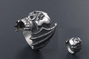 Macro detail of gothic skull ring with bat wings in vintage silver stainless steel