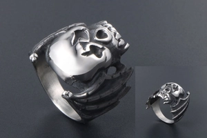 Macro detail of vintage punk skull ring with bat wing design in distressed steel finish