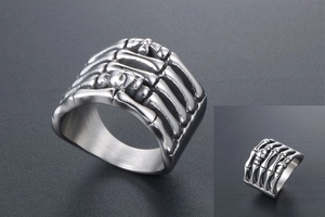 Macro detail of punk rock skull ring with blackened bone texture and steel finish