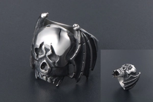 Detailed macro view of gothic punk skull and bat wings on stainless steel ring