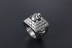 Detailed macro view of retro skull pyramid carvings on the stainless steel ring surface