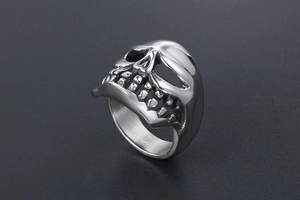 Detailed side view of a polished titanium steel skull ring with vintage gothic textures