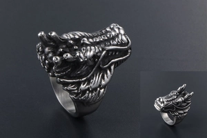 Close-up of vintage dragon ring featuring detailed scales and blackened metal finish