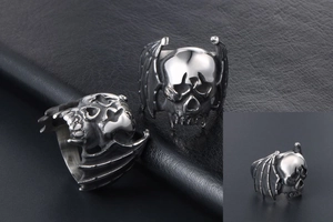 Detail of gothic bat skull ring showing intricate wing textures and vintage steel finish