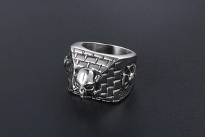 Macro shot of gothic skull and brick wall relief detail on vintage stainless steel ring