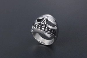 Macro shot of punk style titanium steel skull ring with detailed silver finish