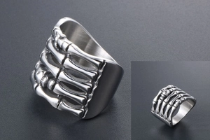 Macro shot of punk skeleton hand ring in silver titanium steel with detailed bone joints