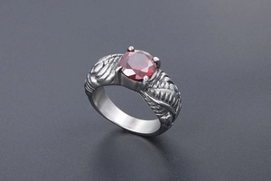 Macro shot of vintage wing ring featuring a large red gemstone in four-prong setting