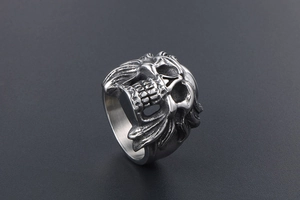 Detailed side view of vintage skull ring with intricate metal wings in punk style