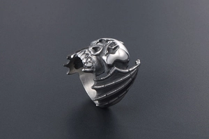 Macro view of vintage bat skull ring in titanium steel with detailed black aged finish