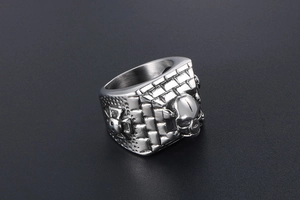 Detailed view of punk skull ring with vintage wall patterns in silver stainless steel