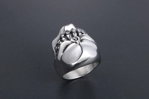 Macro detail of the silver skull teeth design on a polished stainless steel punk ring