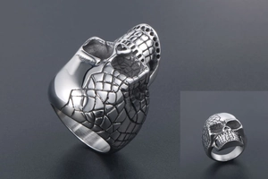 Detailed side view of punk skull ring in vintage silver finish with aged metal textures