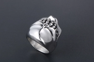 Macro detail of gothic skull ring in vintage silver finish with brushed metal texture
