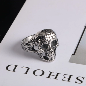 Detailed macro view of punk skull ring with unique pebble texture in vintage silver steel