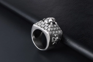 Detail of gothic stainless steel ring with skull castle and cross on leather