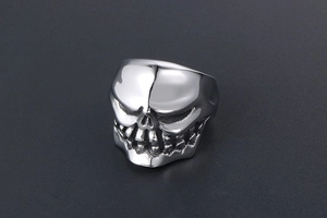 Macro detail of silver titanium steel skull ring with vintage distressed finish for men