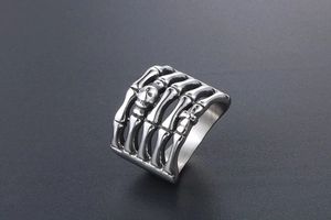 Macro detail of gothic stainless steel ring with skull and skeleton bone engravings