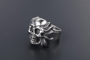 Macro shot of punk style skull ring in vintage silver finish with wing details