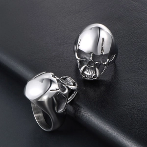 Gothic skull rings in polished stainless steel showing front and side views on leather