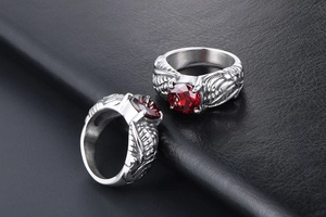Macro detail of retro punk dragon claw ring featuring a round red gemstone inlay
