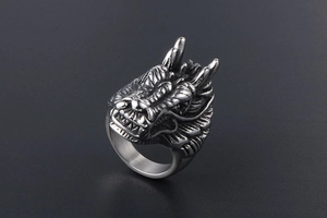 Detailed close-up of a vintage punk dragon head ring in oxidized silver titanium steel
