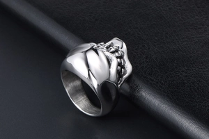 Macro shot of silver stainless steel skull ring with vintage black etched details