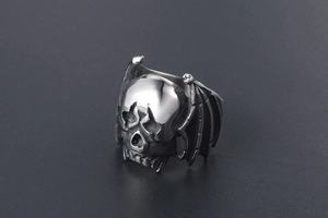Detailed macro shot of vintage gothic skull ring with bat wings in stainless steel