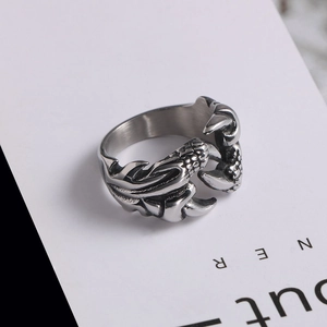 Macro detail of retro dragon claw stainless steel ring with intricate scale engraving