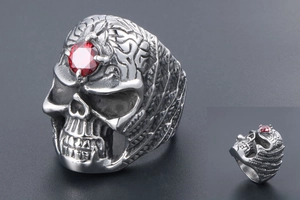 Macro detail of gothic skull ring with red gemstone and antique silver engravings