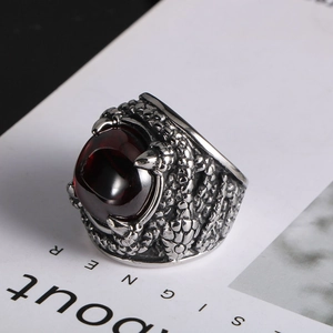 Detailed close-up of retro dragon claw ring featuring a deep red circular gemstone