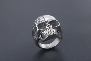 Macro shot of punk skull ring with half-polished and half-textured honeycomb finish