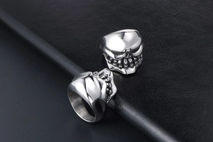 Macro shot of punk style stainless steel skull ring with detailed tooth and eye socket