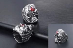 Detailed macro shot of a gothic skull ring with red gemstone in stainless steel